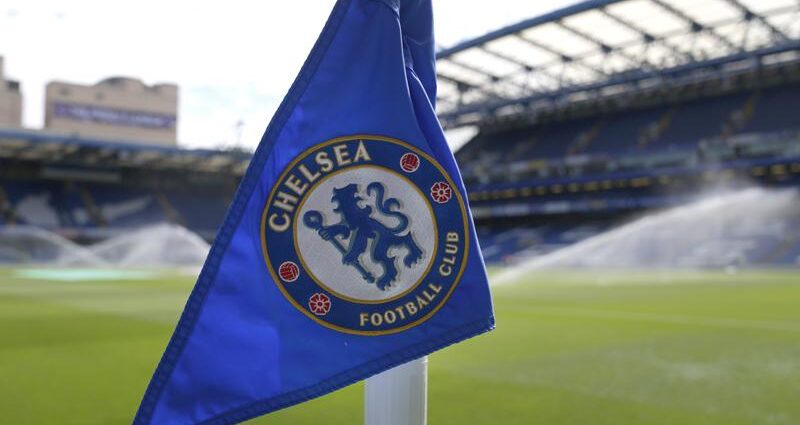 Un banderín de esquina con el logo del club Chelsea aparece colocado cuando la cancha es regada previo al duelo de la Liga Premier entre Chelsea y Watford en el estadio Stamford Bridge de Londres, el domingo 22 de mayo de 2022.(AP Foto/Alastair Grant)